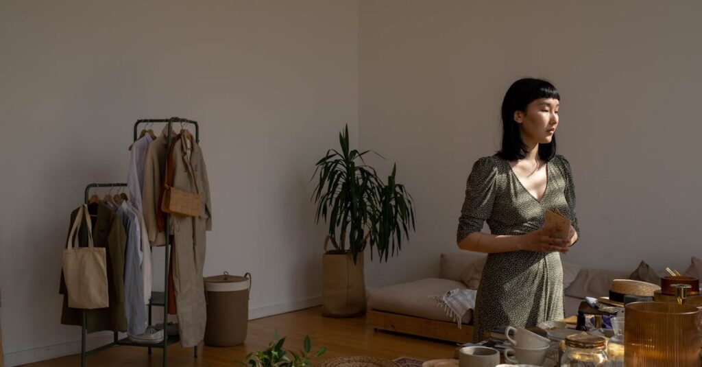 An Asian woman holding a notebook in a softly lit modern indoor space.